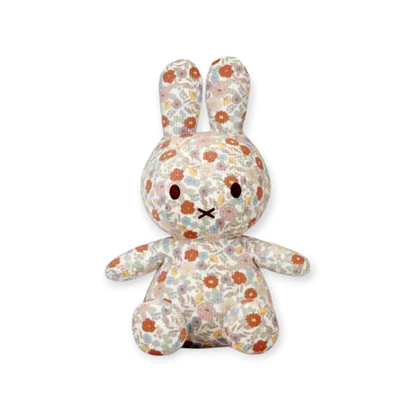 The delightful Miffy Plush Vintage Flowers All Over - 25cm, adorned with a vintage floral pattern and oversized, floppy ears, sits elegantly against a pristine white background.