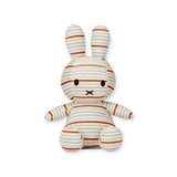 The Miffy Plush Vintage Stripes All Over - 25cm is a delightful stuffed bunny showcasing a blend of horizontal pastel stripes and black stitched features. Sitting upright against a white background, it offers both a nostalgic and contemporary charm, perfect for those who appreciate timeless designs similar to the Little Dutch collaboration.