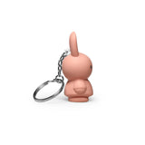 The Miffy Keychain - Powder by Miffy is a small, pink, rabbit-shaped keychain with a metal chain and ring. It features a minimalist design that modernizes the classic look of the Miffy Bunny Keychain and is depicted from the side against a white background.