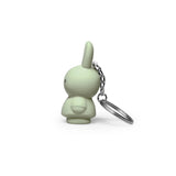 Side view of the Miffy Keychain in powder color, showcasing a charming bunny shape with a modern twist. It features a minimalist design and comes with an attached metal ring.