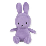 The Miffy Bunny Plush Corduroy - Lilac 23cm, presented by the brand Miffy, is an eco-friendly option featuring long ears, black eyes, and a small X-shaped nose in an upright sitting position. This adorable plush toy offers a hypoallergenic choice without losing its charming appeal.