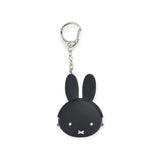 The Miffy Keychain Pouch - Black by Miffy is a bunny head-shaped keychain with long ears and a simple facial expression, made from premium Japanese silicone on a white background.