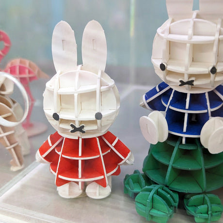 Miffy 3D paper puzzle figure in red dress, eco-friendly and tool-free craft from SI-GU-MI series displayed on shelf.