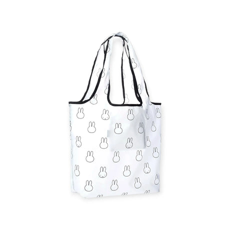 The Miffy Reusable Shopping Bag, by Miffy, is a compact and practical option featuring a lightweight design adorned with a charming black outline bunny face pattern and sleek black trim on the handles and edges.