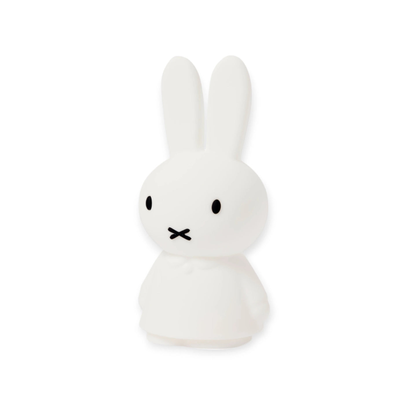 A white cartoon bunny with long ears, small eyes, and a simple mouth stands upright on a plain background, resembling the Miffy Shines - Night Light (22cm) by Miffy.