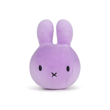 The Miffy Squish Relief Ball - Lilac by Miffy is a round, lavender plush toy with rabbit ears, black stitched eyes, an X-shaped mouth, eco-friendly filling, and shown on a plain white background.