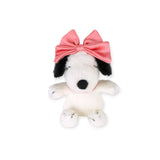 White-and-black dog plush with large pink bow, standing upright