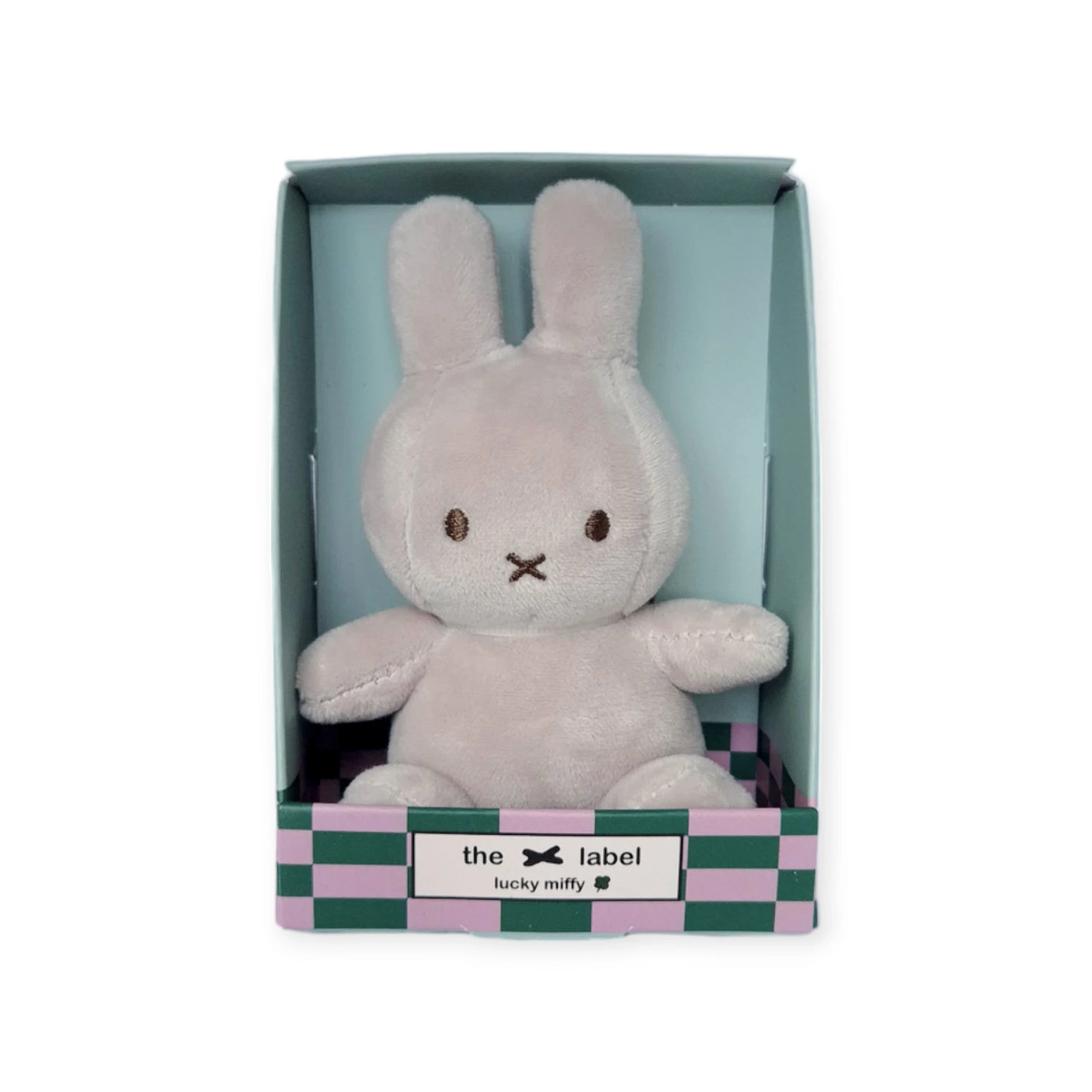 A Mini Miffy Plush bunny, known as the Grey Lucky Charm from the Miffy brand, comes nestled inside a green and pink checkered box labeled "Lucky Nifty," perfect for bringing a soft and cuddly vibe to your day.