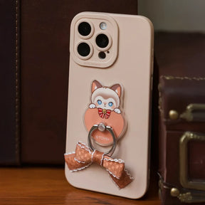 Beige smartphone with Siamese cat phone ring holder featuring a small ribbon bow attached to the back