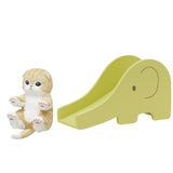 A charming Mofusand toy kitten from the Mofusand Blind Box - Cats on Slides collection sits next to a yellow elephant-shaped slide on a pristine white background.