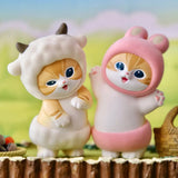 Pair of plush animal blind box figures: white cat in hood and pink cat-hood figure
