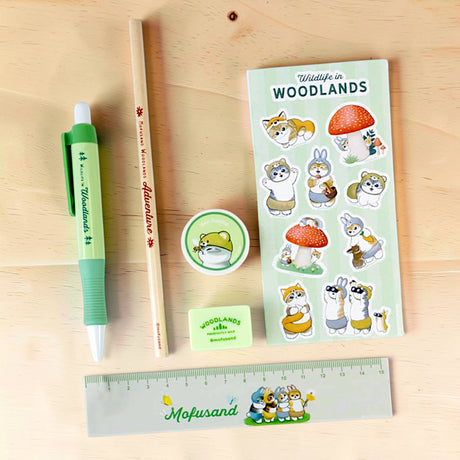Woodlands stationery set items laid out: green pen, pencil, ruler, sticker sheet, tape