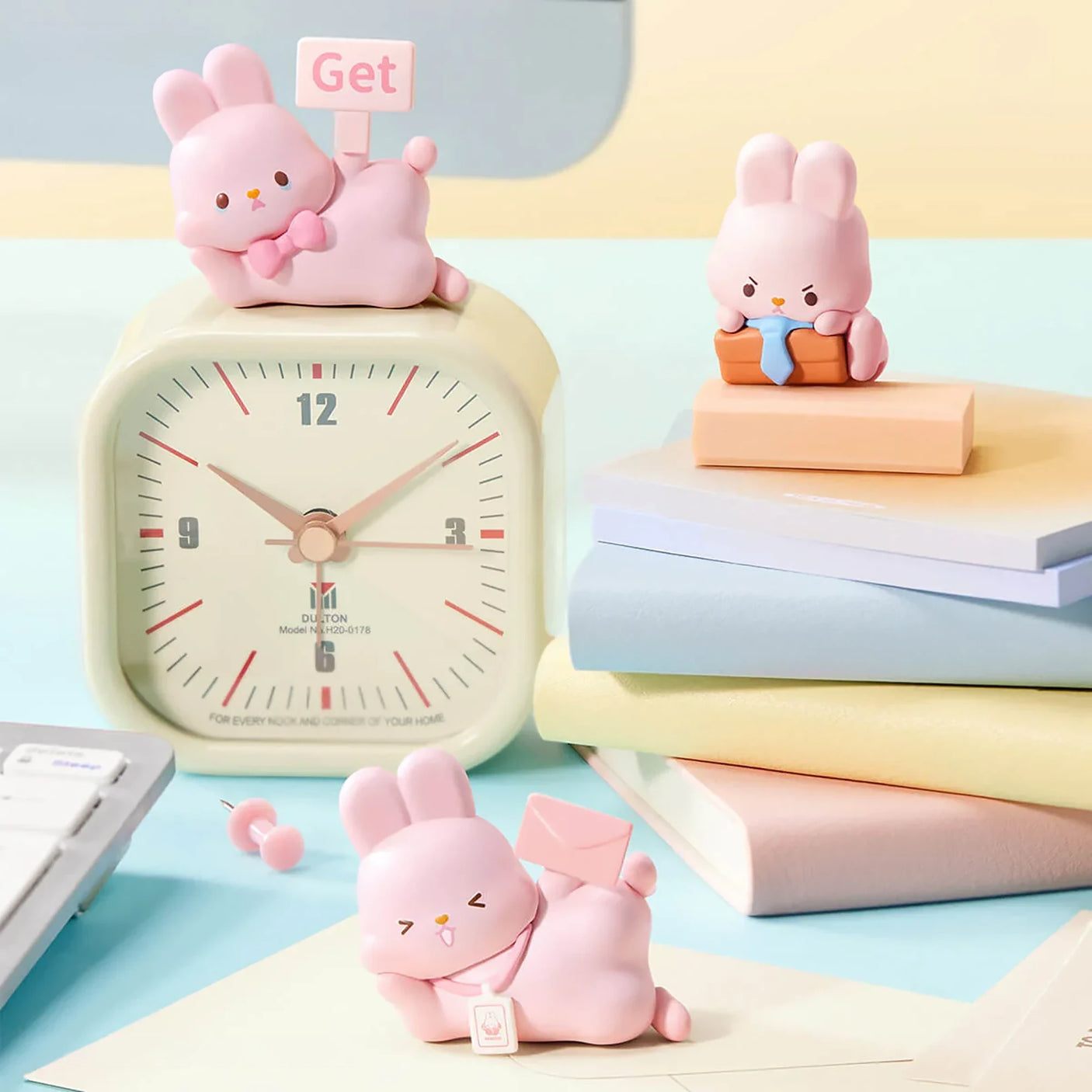 MOMO Bunny 24h Work Life Diary - Blind Box with three pastel pink bunny figures in office scenes with clock and books.