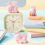 MOMO Bunny 24h Work Life Diary - Blind Box with three pastel pink bunny figures in office scenes with clock and books.