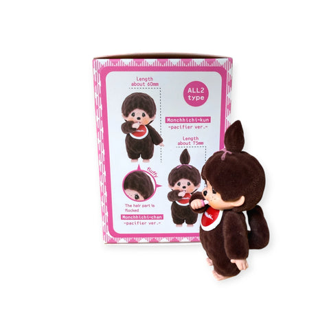 A Monchhichi Flocked Figure from the Original Series stands beside its Blind Box, showcasing vibrant designs and promising a delightful tactile experience with its soft-touch finish.