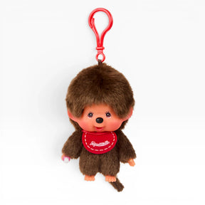 Brown furry boy bag charm with red keychain loop and red shirt; full body view