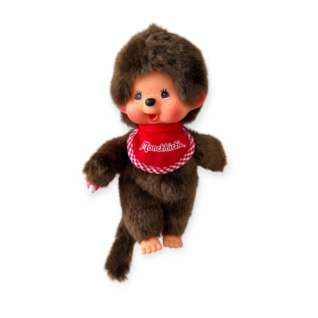 A Monchhichi Plush Doll - Twin Boy with a smiling face and red bib with "Monchhichi" text evokes nostalgia, set against a white background.