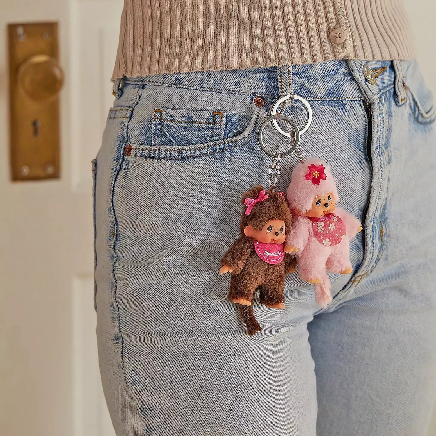 Keychain charms attached to denim jeans with plush girl figures