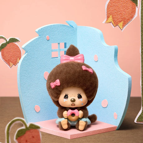 Blue card stand with brown-furred Monchhichi pendant figure wearing a pink bow