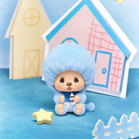 Light blue hooded Monchhichi pendant figure on a white house-shaped base