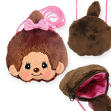 The Monchhichi Mini Bag with strap - Girl by Monchhichi includes a plush face pouch featuring a girl's face and bow, an adjustable pink strap, plain brown fur on the back, and a zippered compartment for essentials.