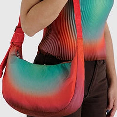 Person wearing a sleeveless, colorful top and carrying a matching gradient-colored shoulder bag.