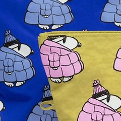 Patterned fabric featuring cartoon polar bears wearing puffy coats and sunglasses, with a pencil case in a similar design. The fabric is blue, and the case is yellow.