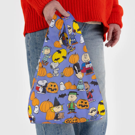 Peanuts Halloween character print baby tote bag in blue fabric held by hand
