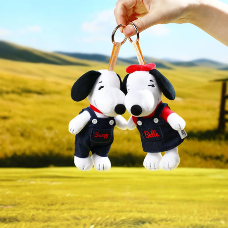 Two Snoopy denim plush keychains holding metal rings, one red-collar one navy