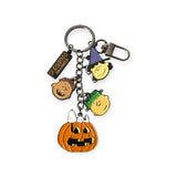 Halloween-themed keychain with Peanuts characters Charlie Brown, Lucy, Linus, Snoopy in pumpkin charm, and Peanuts tag