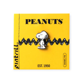 Classic Snoopy enamel pin with black zigzag stripe on bright yellow Peanuts branded backing card