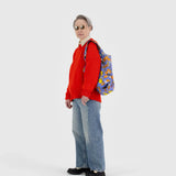 Blue PEANUTS character tote worn by model over red top and light jeans