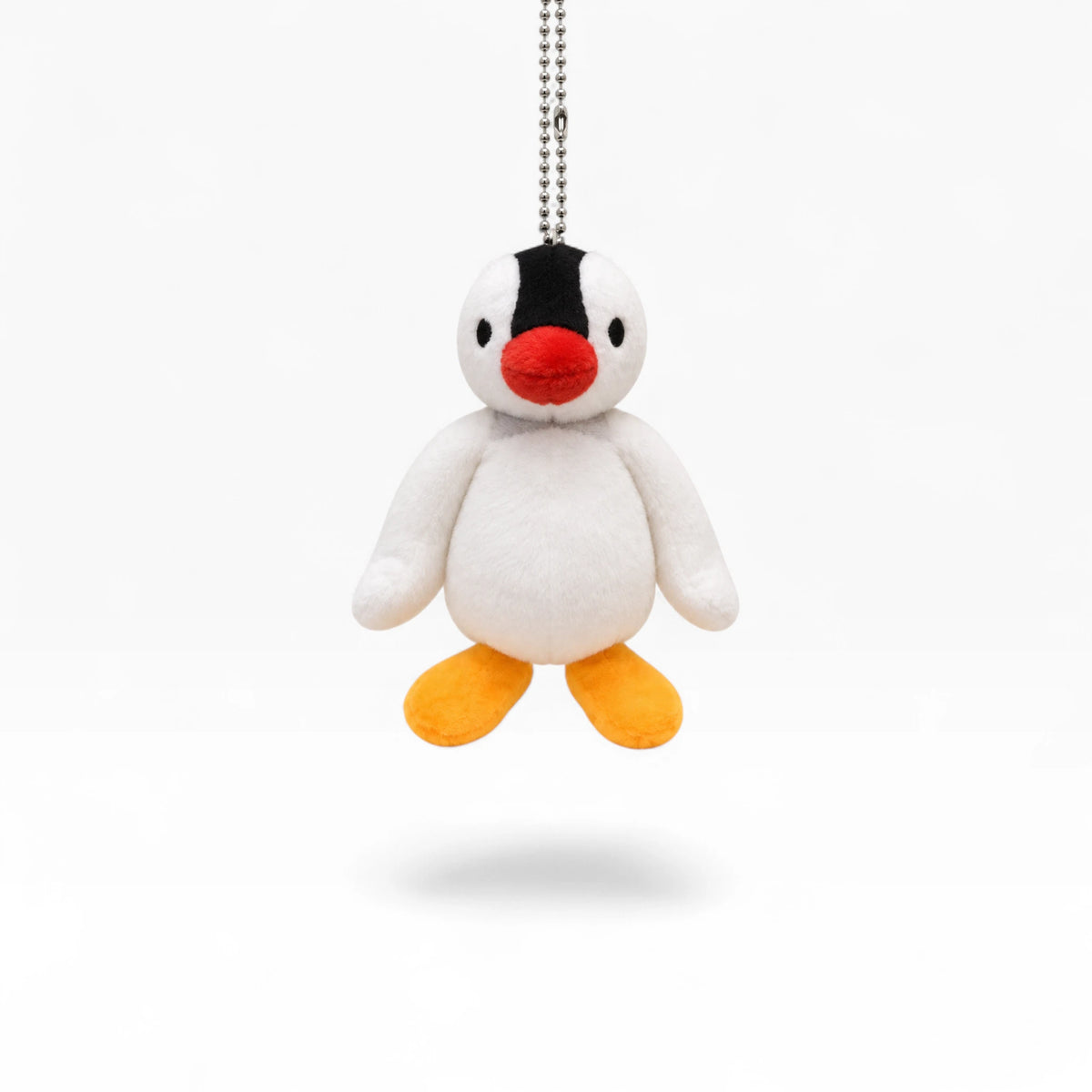 Plush penguin keychain with silver chain, white body, black cap, red beak, orange feet