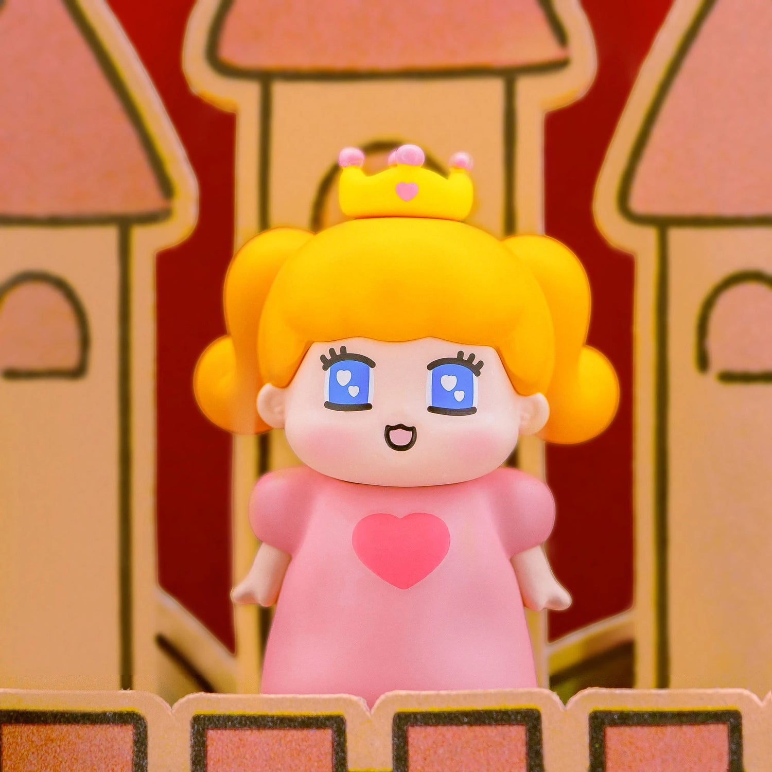 Pink-dress blind-box figurine with orange hair, crown, and heart face emblem.