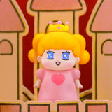 Pink-dress blind-box figurine with orange hair, crown, and heart face emblem.