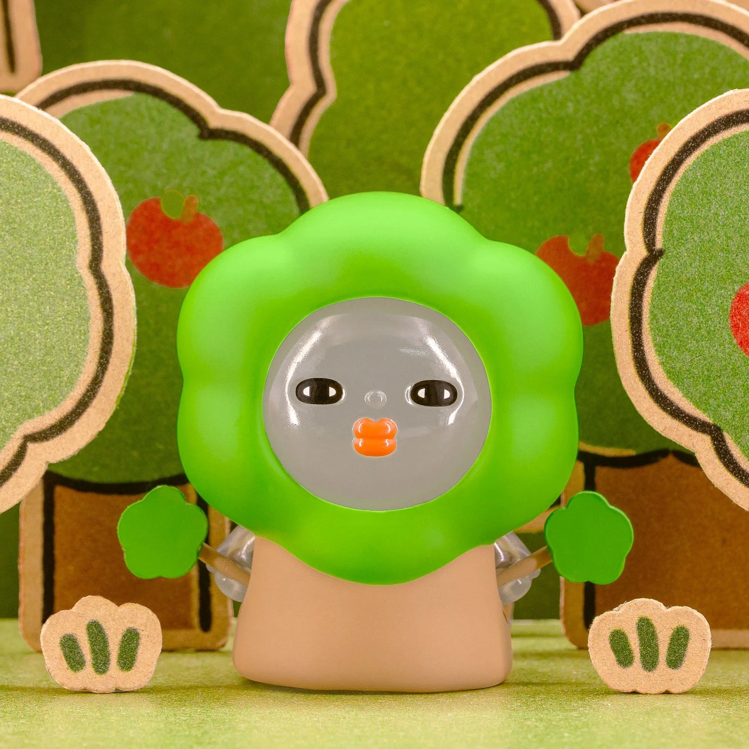 Green-hood blind-box figurine with clear face bubble and orange nose detail.
