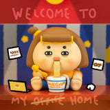 Vinyl collectible character figure with brown hair and blue outfit, holding bowl of noodles