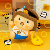 Vinyl collectible character figure in brown hat and orange shirt, with yellow duck accessory