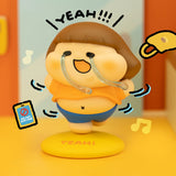 Vinyl collectible character figure in tan cap and blue overalls, holding clear headset