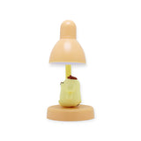 Pompompurin Mini Night Light by Sanrio with yellow character figure beneath peach-colored lamp on round base