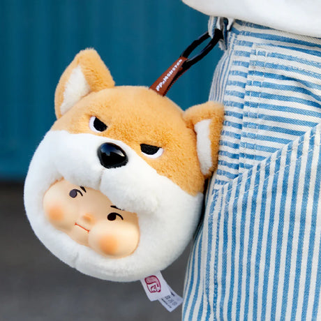 PP x Monster Puppy Bros Plush Keychain - Blind Box showing a plush dog face with a smiling human face keychain by ToyZero+ hanging from striped pants