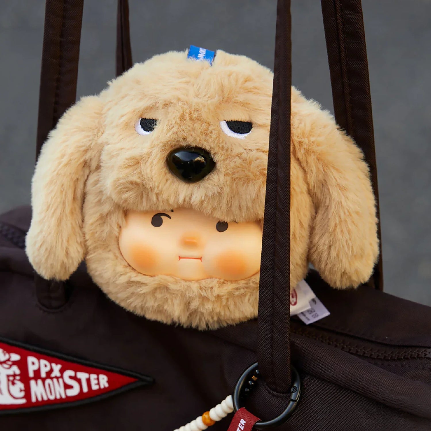 PP x Monster Puppy Bros Plush Keychain - Blind Box showing a plush dog face with sleepy eyes and a small human face inside by ToyZero+