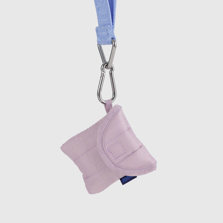 The Baggu Puffy Earbuds Case in Dusty Pink offers sustainable protection for your earbuds with its light purple quilted padding, flap closure, and blue strap secured by a silver carabiner clip.