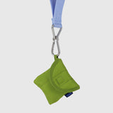 The Baggu Puffy Earbuds Case in Green Juice is a small, quilted pouch made from recycled nylon, attached to a light blue lanyard with a metal clip.