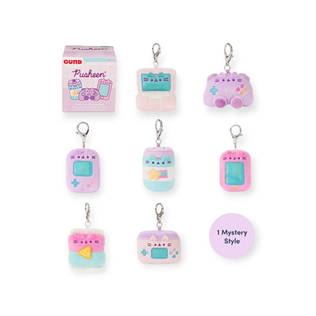 Seven Pusheen Blind Box - Gamer Series plush keychains, inspired by retro electronics, are shown with the product box and a “1 Mystery Style” label, highlighting the fun of collecting these adorable Pusheen surprises.