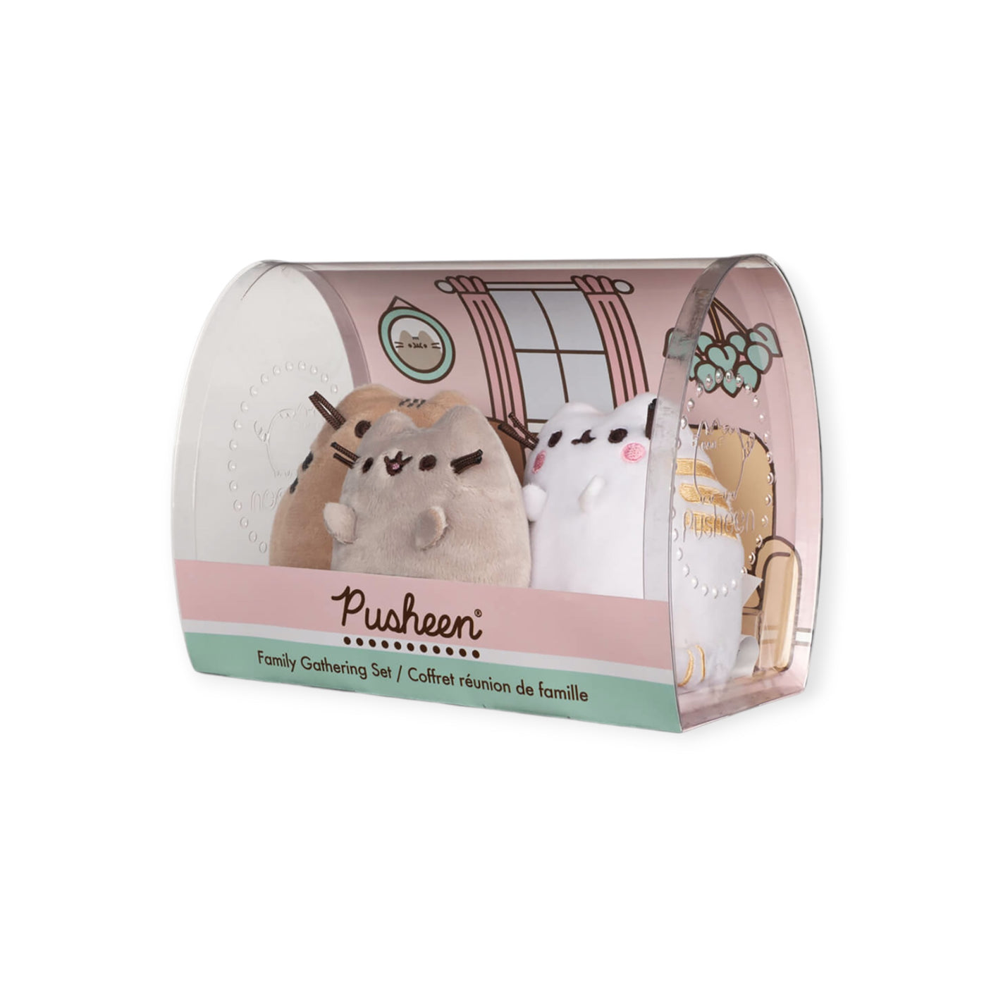 The Pusheen Family - Plushie Gift Set by Pusheen features three adorable plush toys in a cozy, softly lit pastel indoor setting, ideal for a family gathering.