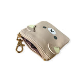 The Rilakkuma Coin Pouch Keychain - 9cm is a small beige pouch featuring a cartoon bear face and ears, made from synthetic leather. It has a zippered top and comes with a gold clasp keychain for easy carrying.