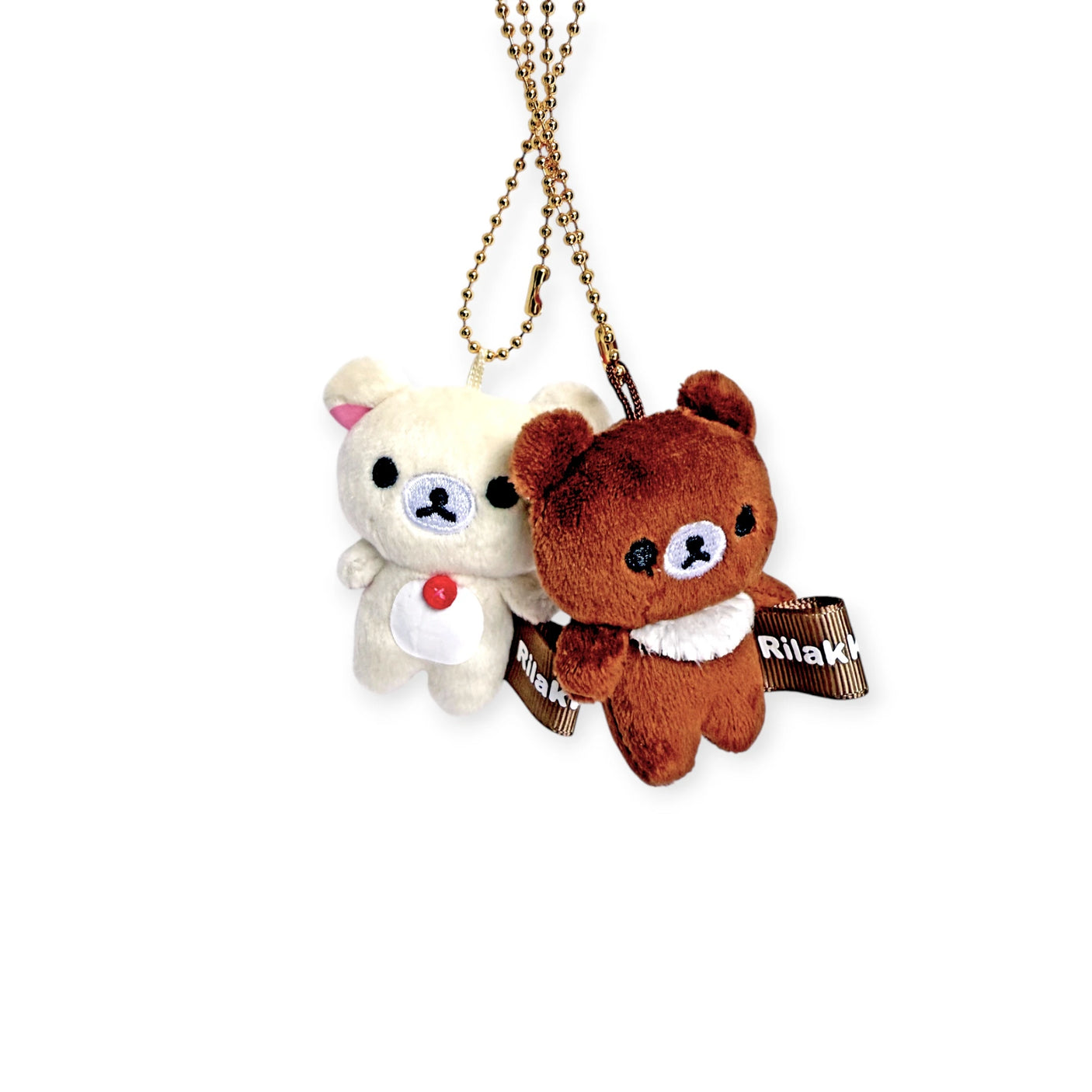 Two small plush bears hang from a brown chain as charming accessories. The cream bear has a red button, and the brown one wears a "Rilakkuma" ribbon. This keychain captures the essence of the Rilakkuma - Chairoikoguma Mini Plush Keychain delightfully.