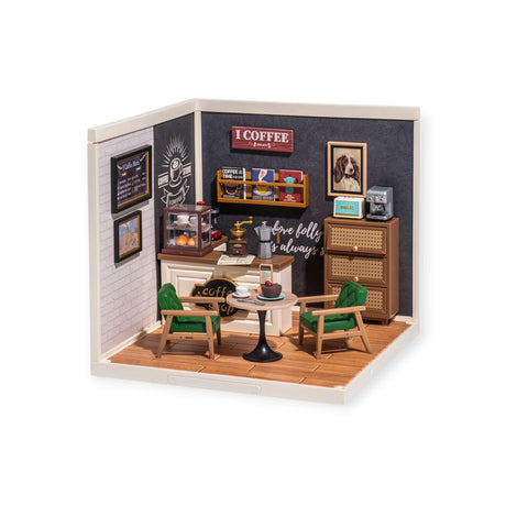 The Rolife Breezy Time Cafe DIY Plastic Mini House lets you build a tiny café model with a table, two chairs, wall shelves with jars and books, a coffee machine, and framed wall art.