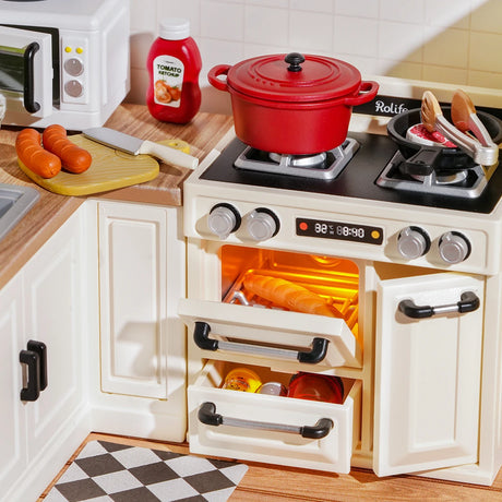 The Rolife Happy Meals Kitchen DIY Plastic Mini House creates a cozy cooking scene with a red pot on the stove, sausages in a frying pan and on a cutting board, rolls in the oven, and a ketchup bottle—perfect for capturing delightful home-cooking vibes.